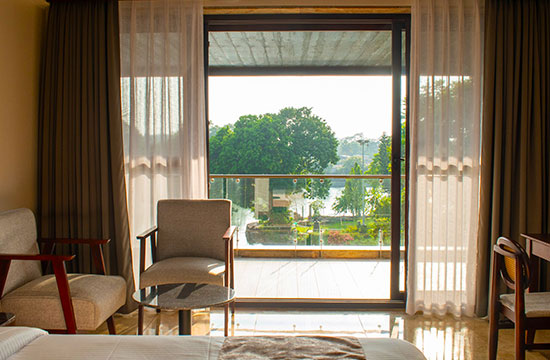 Elegant guest room with balcony at Lakeside Manor