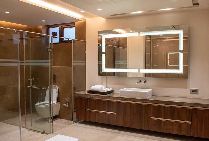 Spacious bathroom with glass‑enclosed shower and illuminated mirror at Lakeside Manor