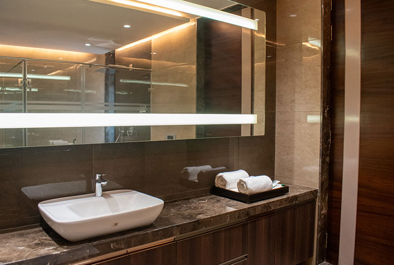 Luxurious bathroom with modern sink and illuminated mirror at Lakeside Manor