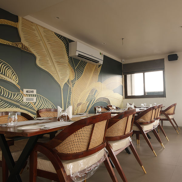 Cozy restaurant dining area with wooden tables, modern chairs and candlelight at Lakeside Manor